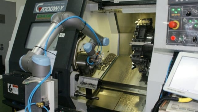Robot unloading a horizontal lathe. (Image courtesy of Zacobria.)
